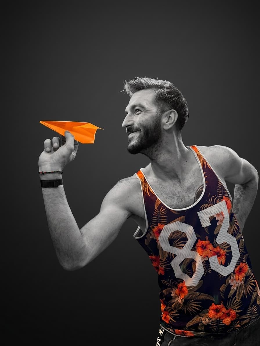 TGV-Media team member holding an orange paper plane